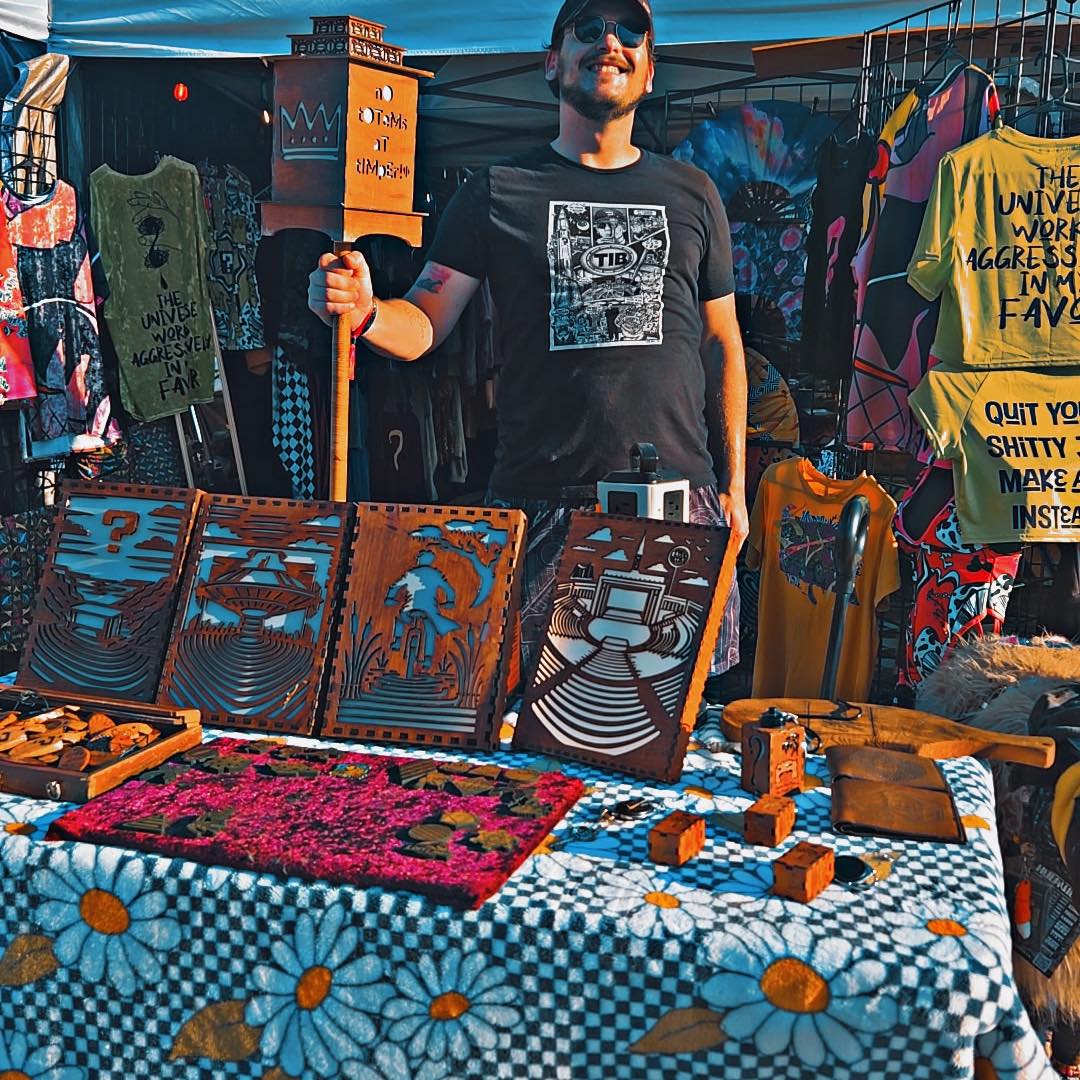 Chandler at the Chandler Allan Arts booth with laser-cut wall art