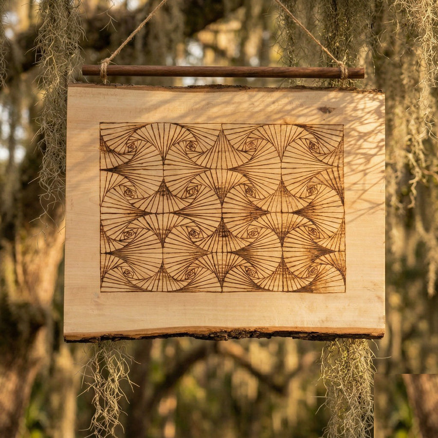 Wood-burned geometric spiral on a live-edge slab